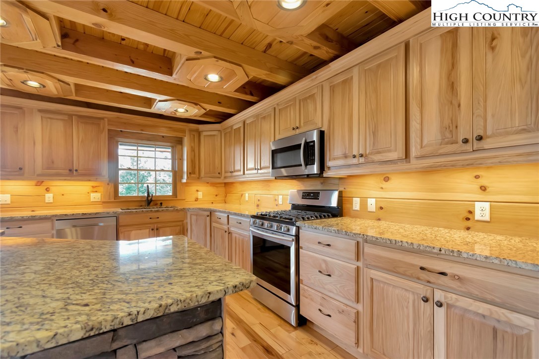 200 Nit Noi Row Boone, NC 28607 - Photo 11 of 45 a kitchen with stainless steel appliances granite countertop a stove sink and cabinets