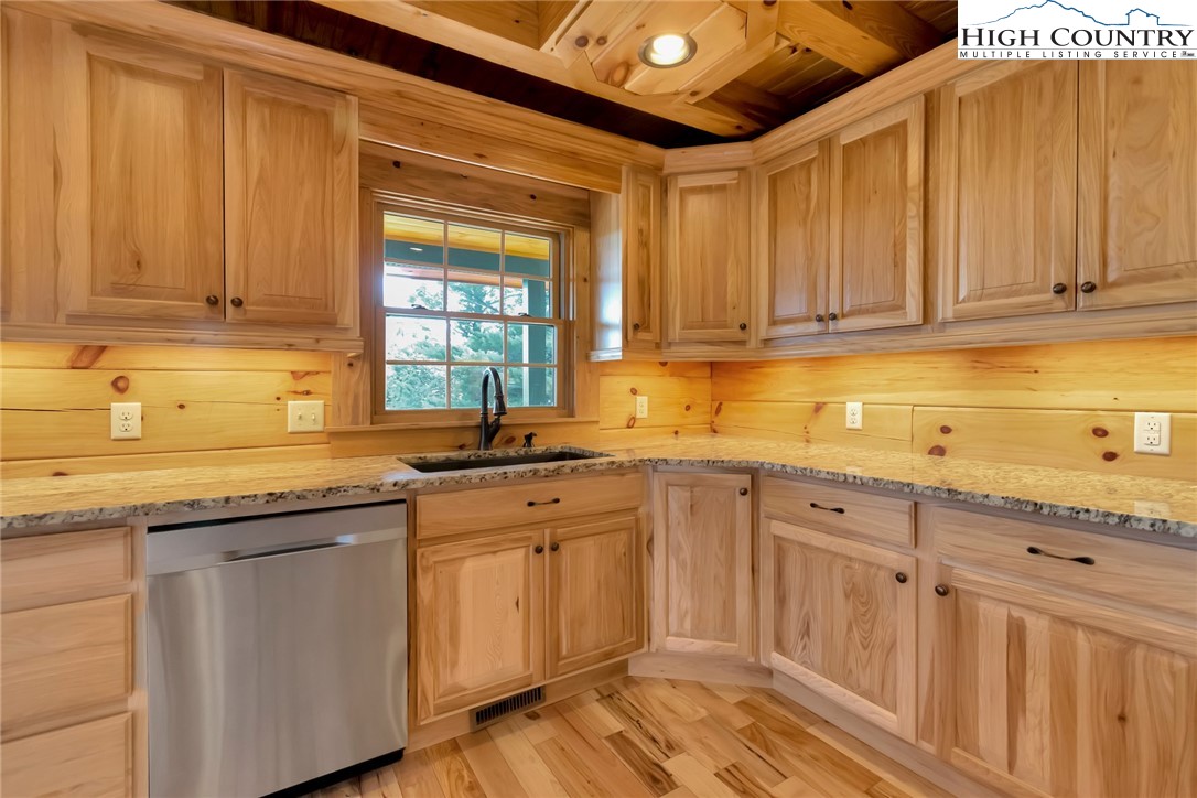 200 Nit Noi Row Boone, NC 28607 - Photo 12 of 45 a kitchen with granite countertop a sink stainless steel appliances and cabinets