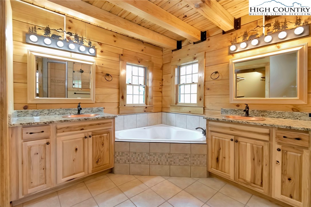 200 Nit Noi Row Boone, NC 28607 - Photo 22 of 45 a bathroom with a granite countertop bathtub sink and mirror