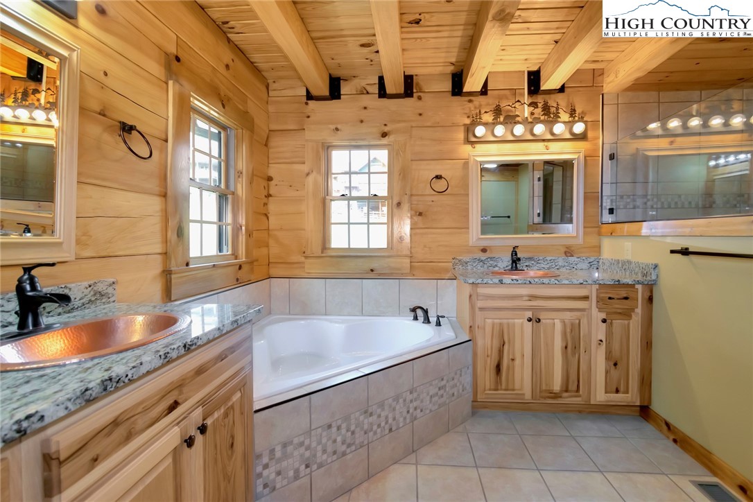 200 Nit Noi Row Boone, NC 28607 - Photo 23 of 45 a spacious bathroom with a granite countertop tub sink and mirror