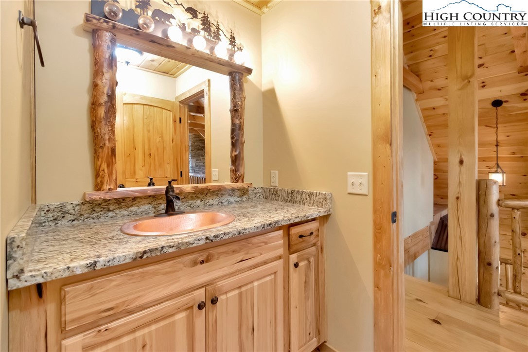 200 Nit Noi Row Boone, NC 28607 - Photo 32 of 45 a bathroom with a granite countertop sink and a mirror