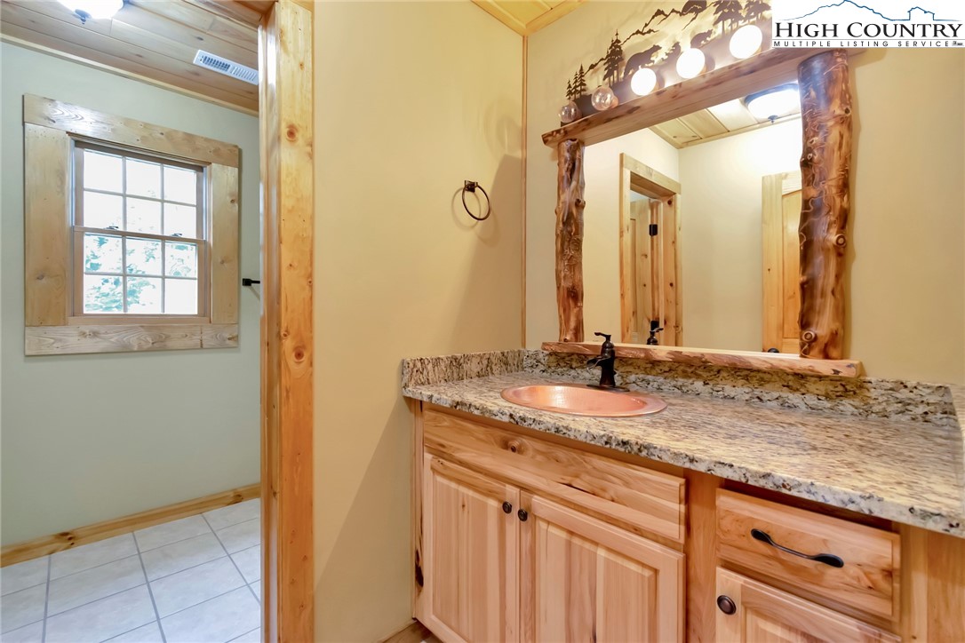 200 Nit Noi Row Boone, NC 28607 - Photo 33 of 45 a bathroom with a granite countertop sink and a mirror