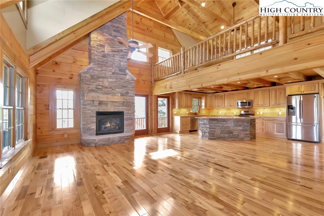 200 Nit Noi Row Boone, NC 28607 - Photo 6 of 45 a view of a hall with wooden floor and a fireplace