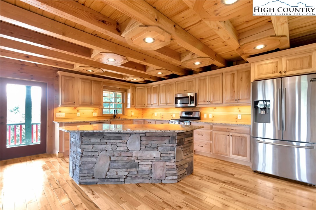 200 Nit Noi Row Boone, NC 28607 - Photo 9 of 45 a kitchen with granite countertop wooden floors and appliances