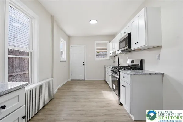 a kitchen with stainless steel appliances granite countertop a stove and a sink