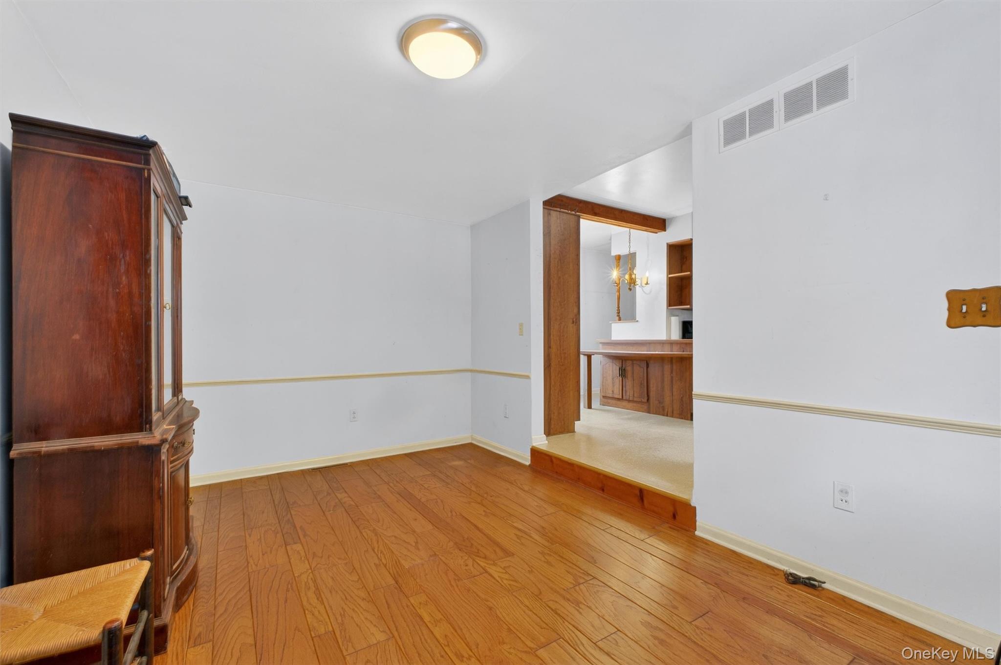 15 Valley View Road Hyde Park, NY 12538 - Photo 15 of 35 Spare room with light wood-style flooring and a chandelier
