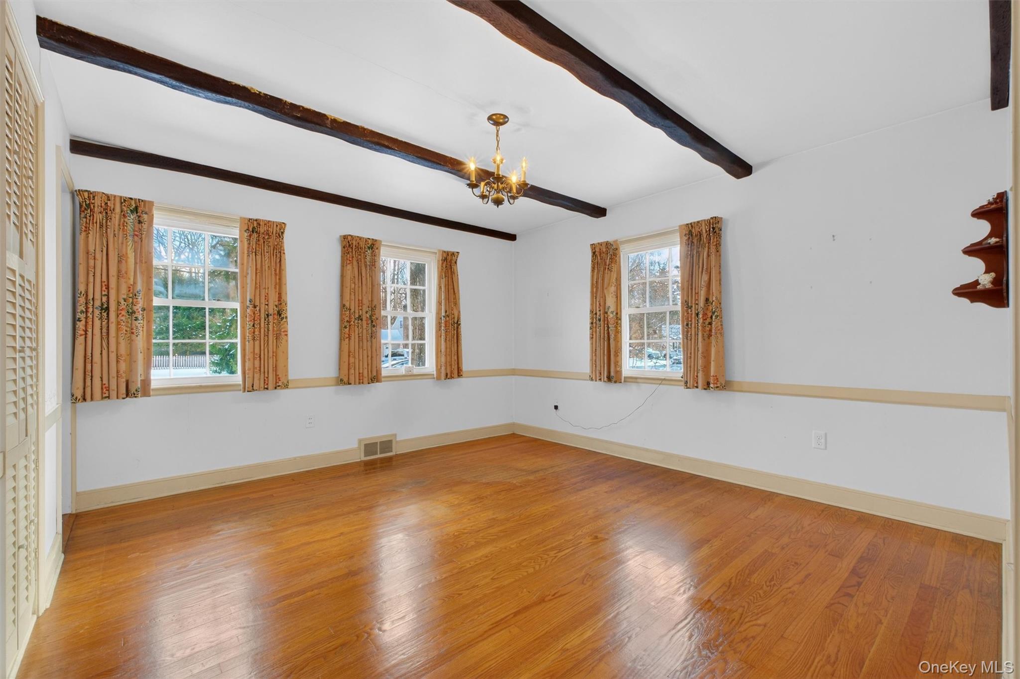 15 Valley View Road Hyde Park, NY 12538 - Photo 18 of 35 Spare room featuring a chandelier, wood finished floors, beam ceiling, and healthy amount of natural light