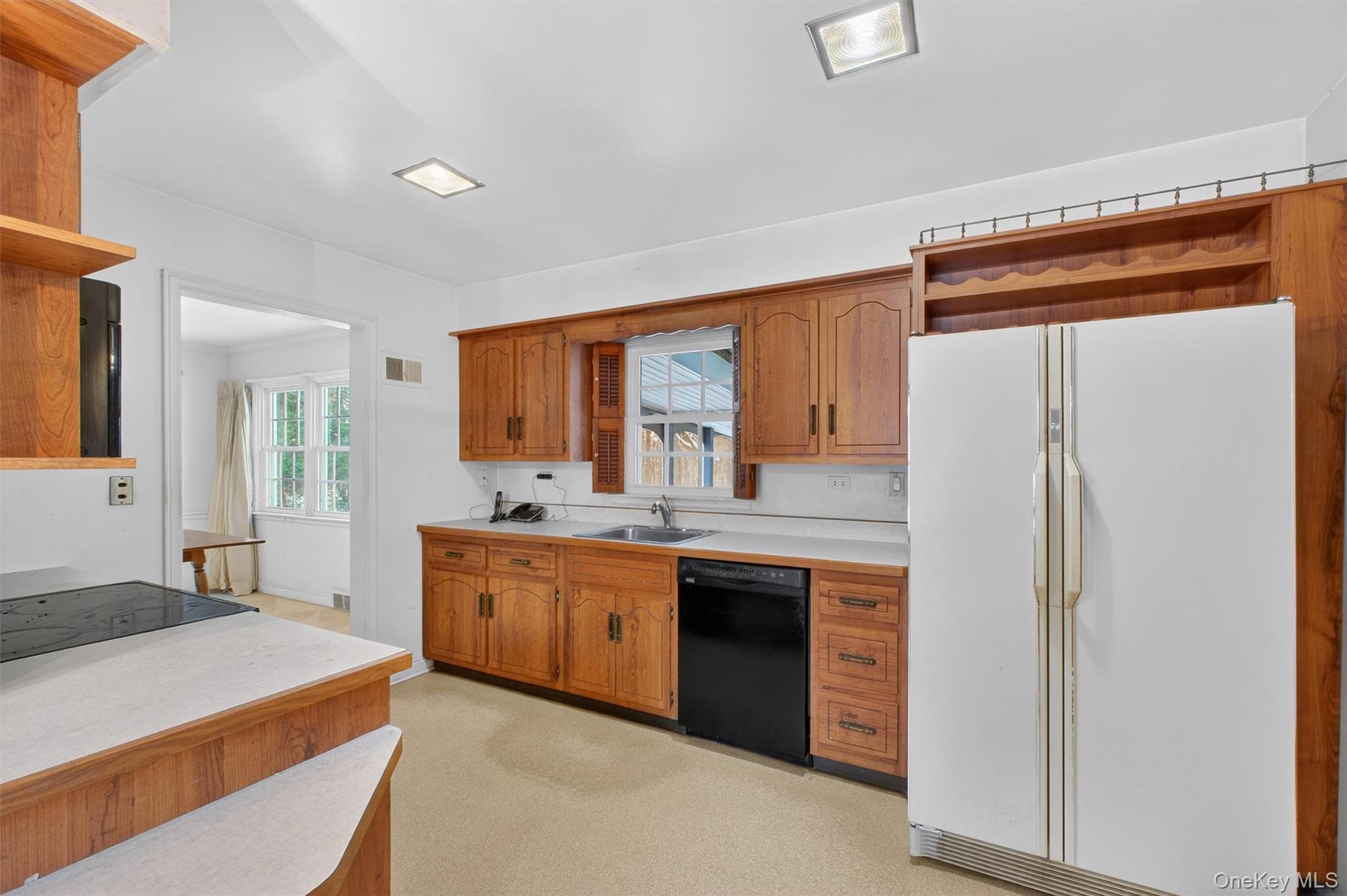 15 Valley View Road Hyde Park, NY 12538 - Photo 7 of 35 Kitchen with open shelves, black appliances, light countertops, and brown cabinetry