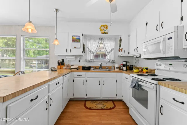 a kitchen with cabinets appliances and a window
