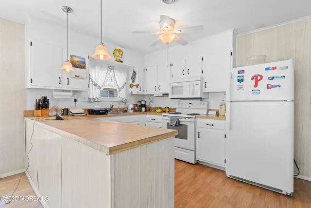 a kitchen with cabinets and window
