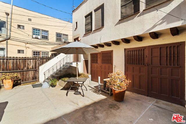 a view of a patio with table and chairs potted plants