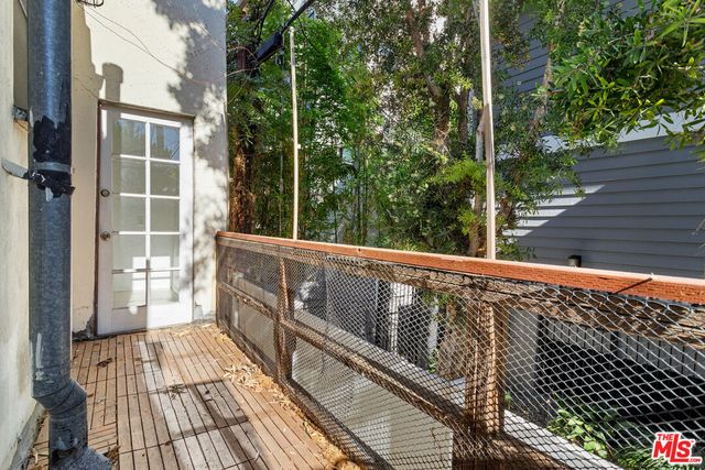 a view of balcony with wooden floor and fence