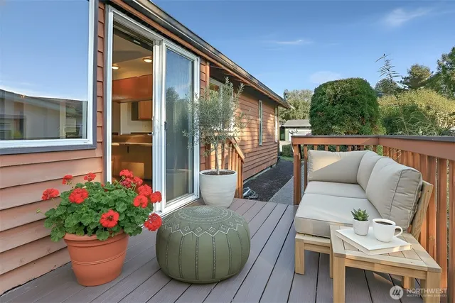 a view of a patio with couches table and chairs and potted plants