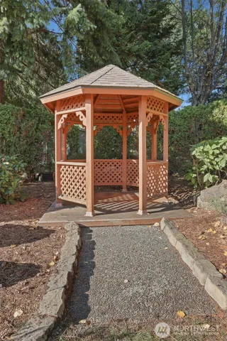 a backyard of a house with table and chairs
