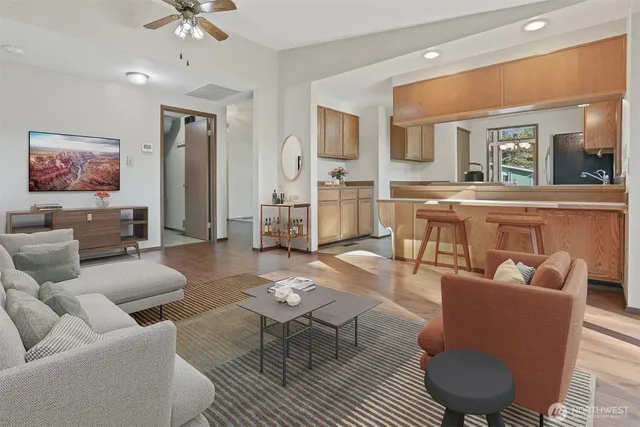 a living room with furniture a rug and a chandelier