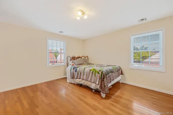 a bedroom with a bed lamp and window