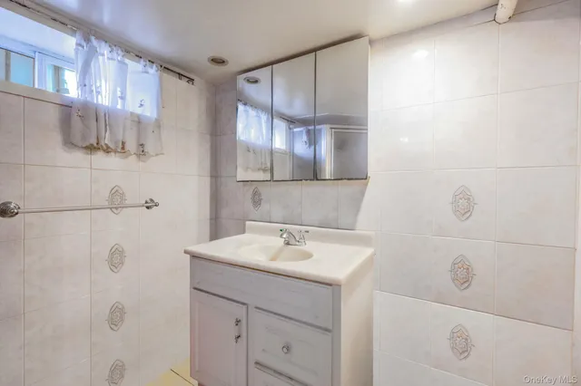 a bathroom with a sink a vanity and a mirror