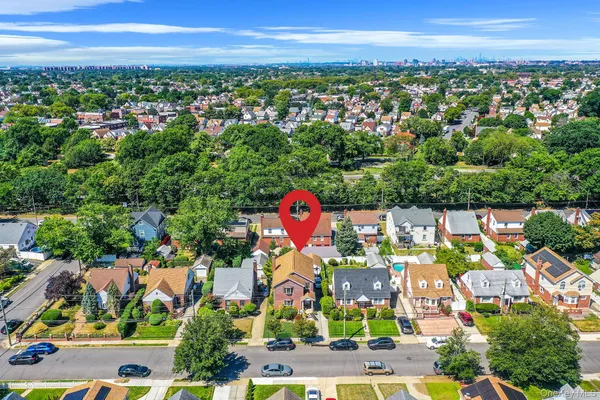 an aerial view of residential houses with outdoor space and swimming pool