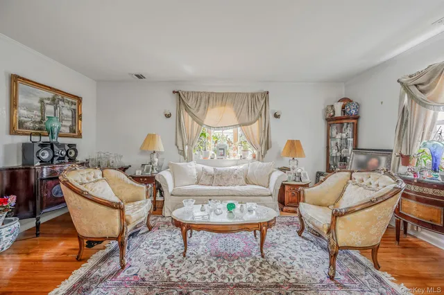 a living room with fireplace furniture and a table