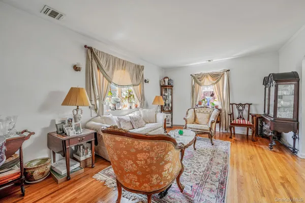 a living room with furniture and a lamp