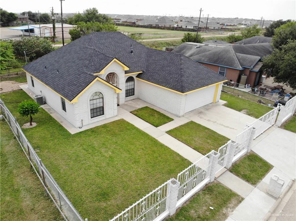 a aerial view of a house with a yard