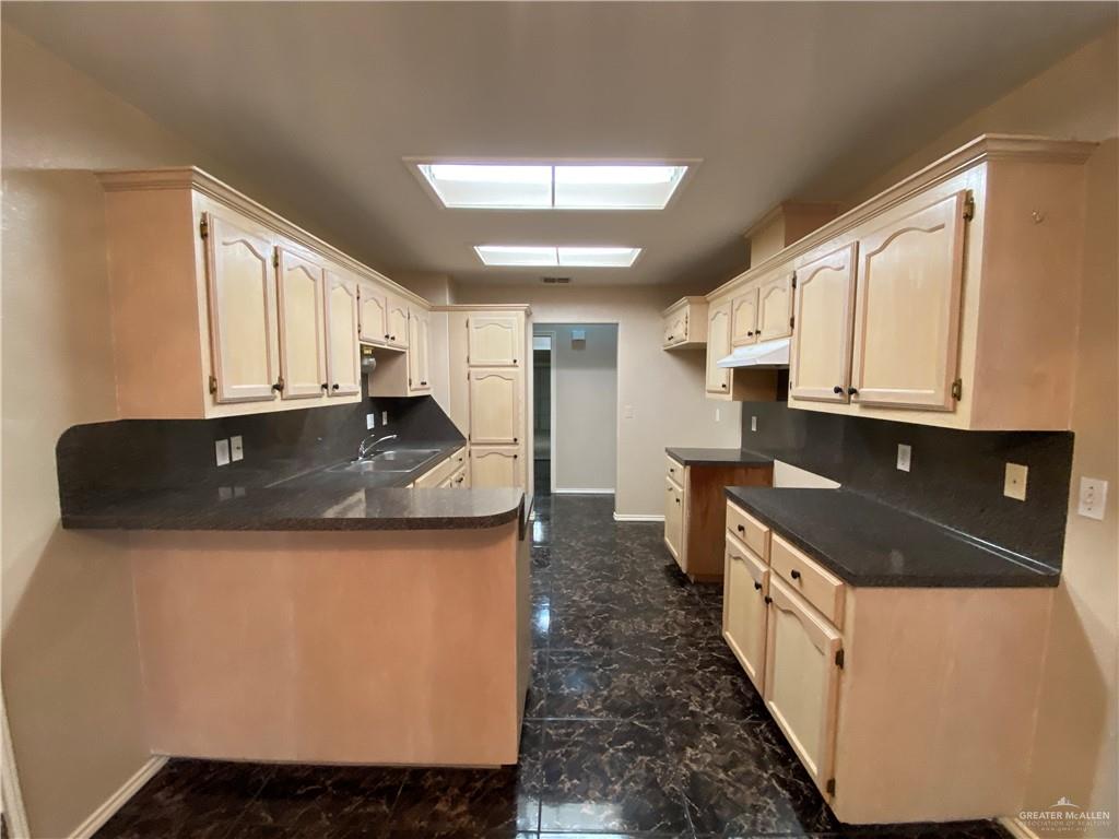 2207 Paseo Encantado Mission, TX 78572 - Photo 22 of 44 a kitchen with stainless steel appliances granite countertop a sink and a stove