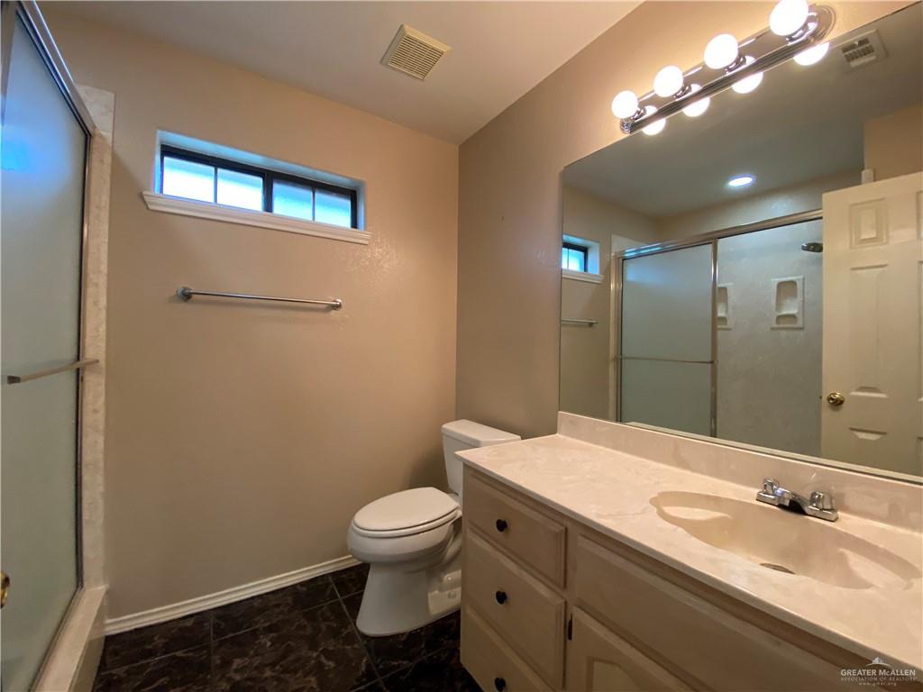 2207 Paseo Encantado Mission, TX 78572 - Photo 29 of 44 a bathroom with a toilet a sink and mirror