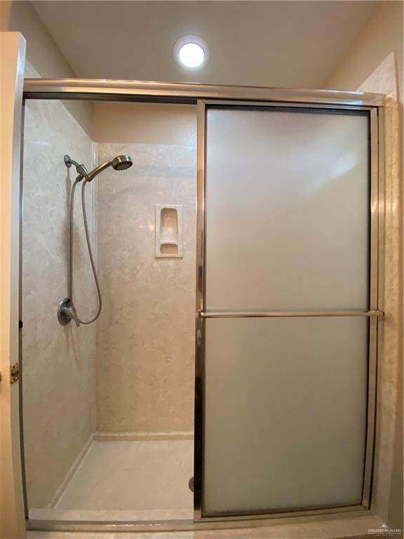 2207 Paseo Encantado Mission, TX 78572 - Photo 30 of 44 a bathroom with a glass shower door