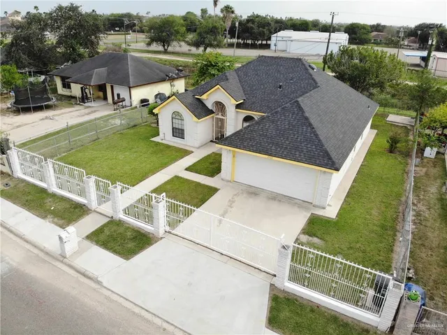 an aerial view of a house with backyard