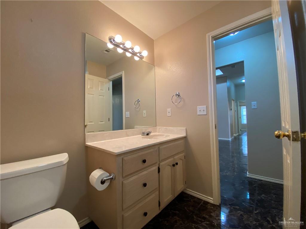 2207 Paseo Encantado Mission, TX 78572 - Photo 32 of 44 a bathroom with a toilet sink and mirror