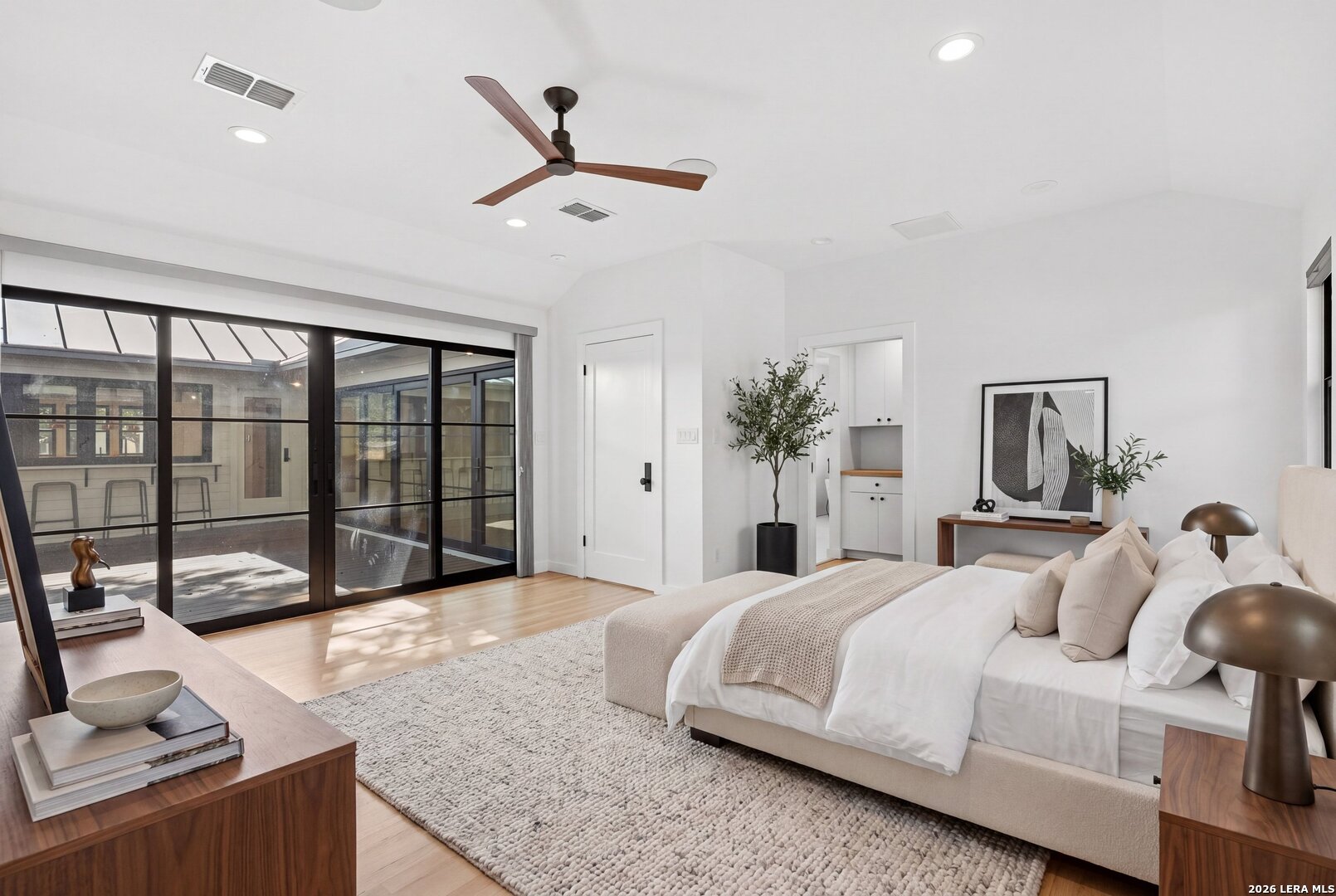 1402 Hutto Road Georgetown, TX 78626 - Photo 24 of 34 a spacious bedroom with a large bed and a chandelier