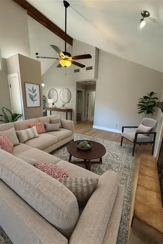 a living room with furniture and a chandelier