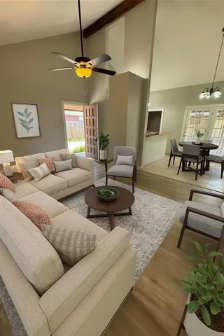 a living room with furniture and a chandelier