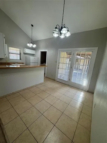 a view of a livingroom with furniture wooden floor and chandelier
