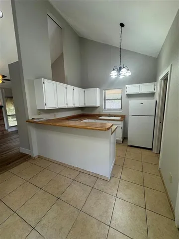a kitchen with stainless steel appliances a sink a stove a refrigerator and cabinets