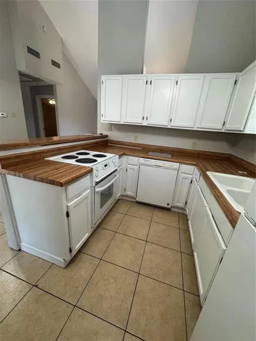 a kitchen with cabinets and appliances