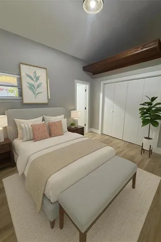 a bedroom with a bed and painting on the wall