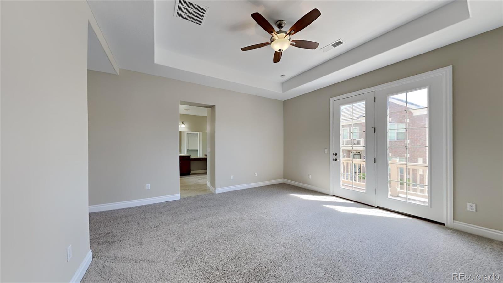 9237 Mornington Way Lone Tree, CO 80124 - Photo 11 of 24 an empty room with windows and ceiling fan