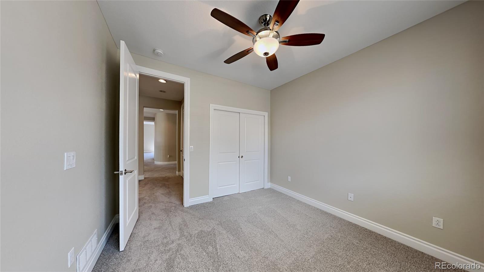9237 Mornington Way Lone Tree, CO 80124 - Photo 17 of 24 an empty room with a ceiling fan and a window