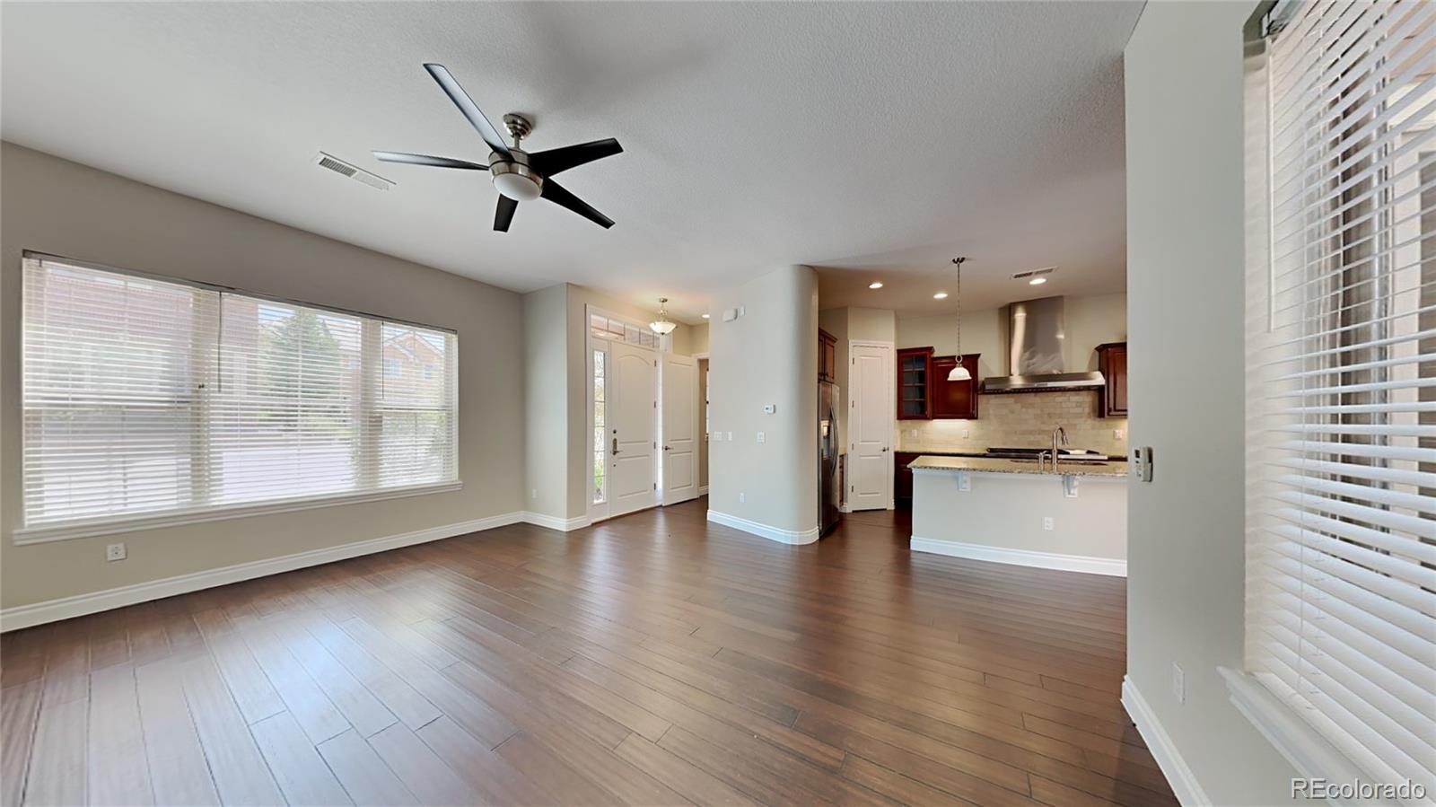 9237 Mornington Way Lone Tree, CO 80124 - Photo 6 of 24 a view of a kitchen with a sink and wooden floor