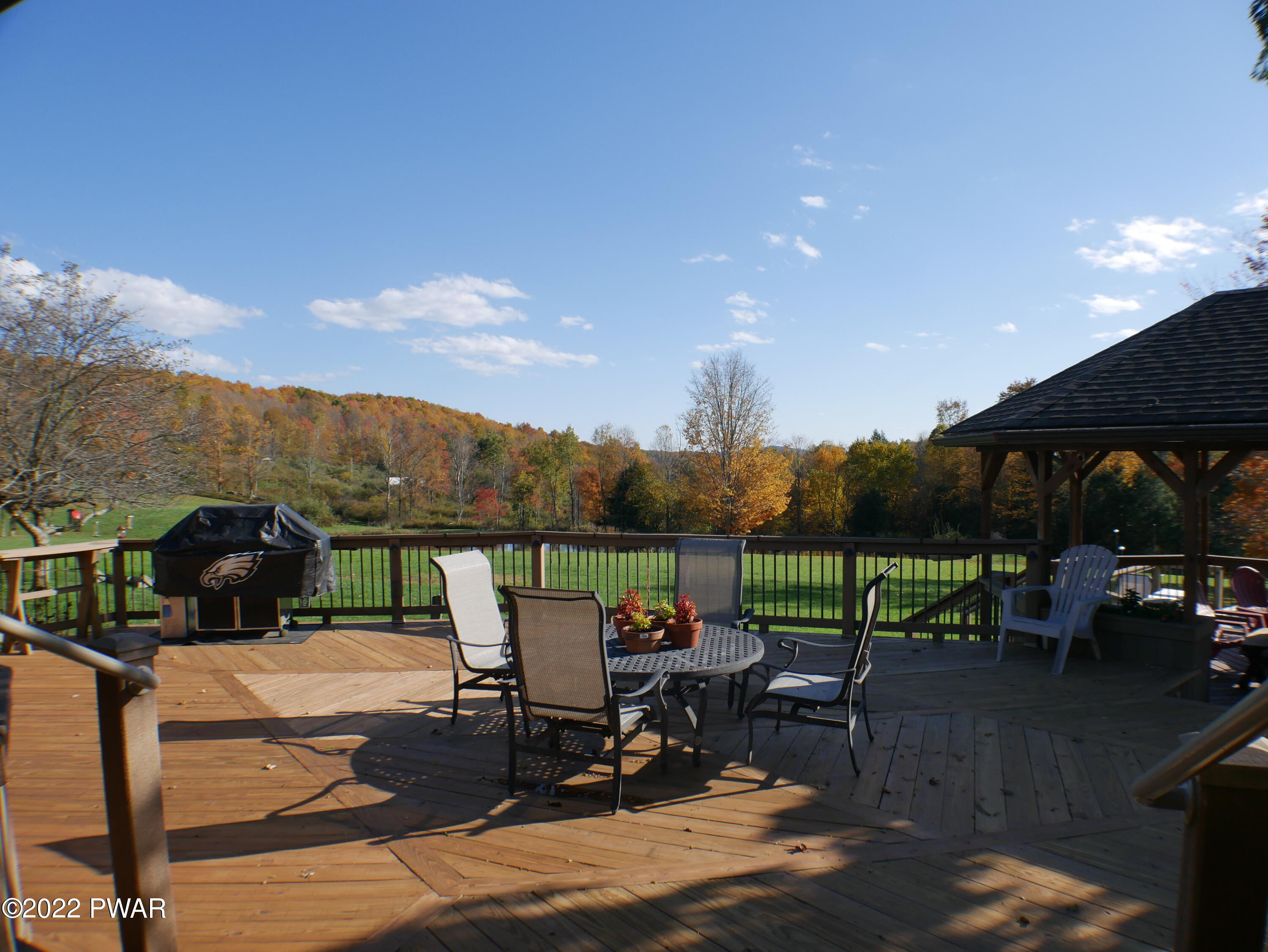 1259 Dougherty Road Meshoppen, PA 18630 - Photo 25 of 61 a view of a patio with table and chairs under an umbrella