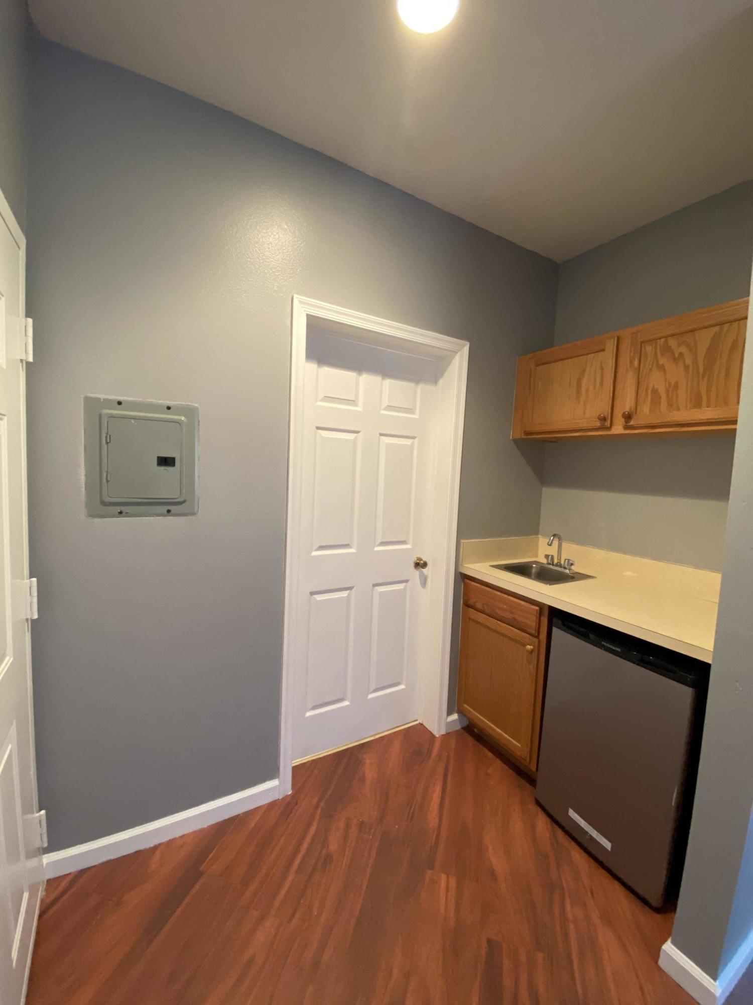 8377 Mulligan Circle, Unit SIDE B Port St. Lucie, FL 34986 - Photo 12 of 17 a view of a kitchen with wooden floor and electronic appliances