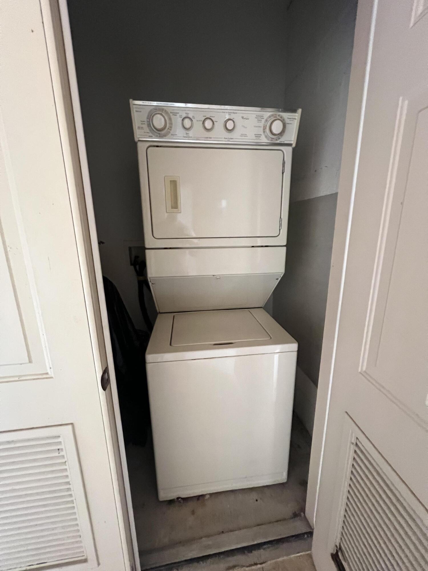 8377 Mulligan Circle, Unit SIDE B Port St. Lucie, FL 34986 - Photo 8 of 17 a utility room with dryer and washer