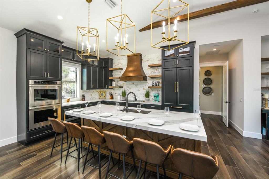 340 Jackson Drive Sarasota, FL 34236 - Photo 14 of 100 a dining room with stainless steel appliances kitchen island granite countertop furniture and wooden floor