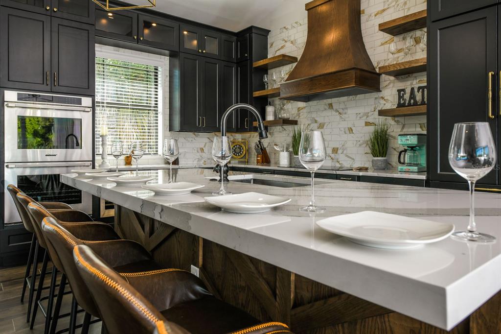 340 Jackson Drive Sarasota, FL 34236 - Photo 22 of 100 a kitchen with a sink a stove and a wooden cabinets