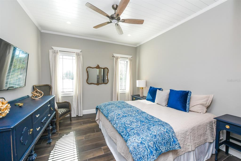 340 Jackson Drive Sarasota, FL 34236 - Photo 46 of 100 a bedroom with a large bed and a chandelier