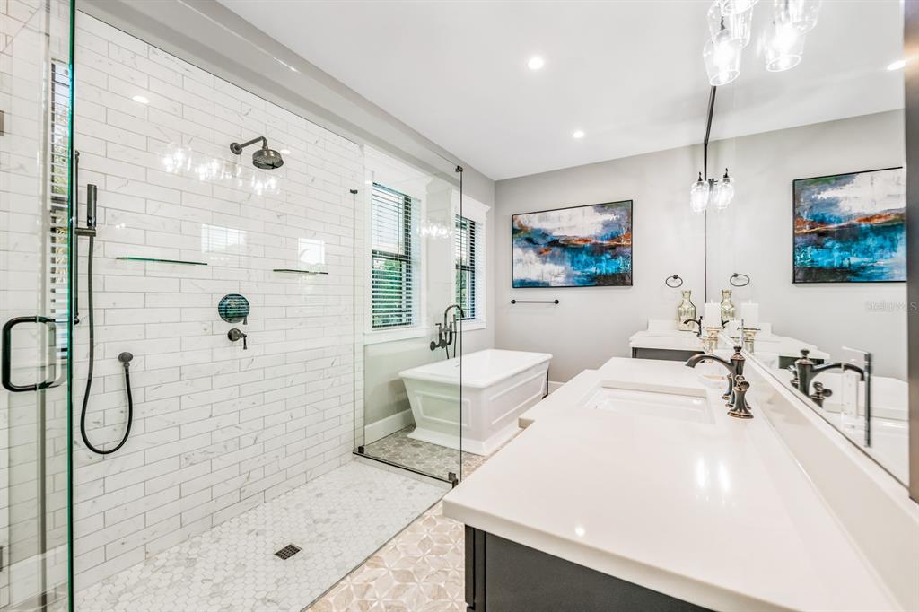 340 Jackson Drive Sarasota, FL 34236 - Photo 58 of 100 a spacious bathroom with a double vanity sink a mirror a glass door a shower and a glass door