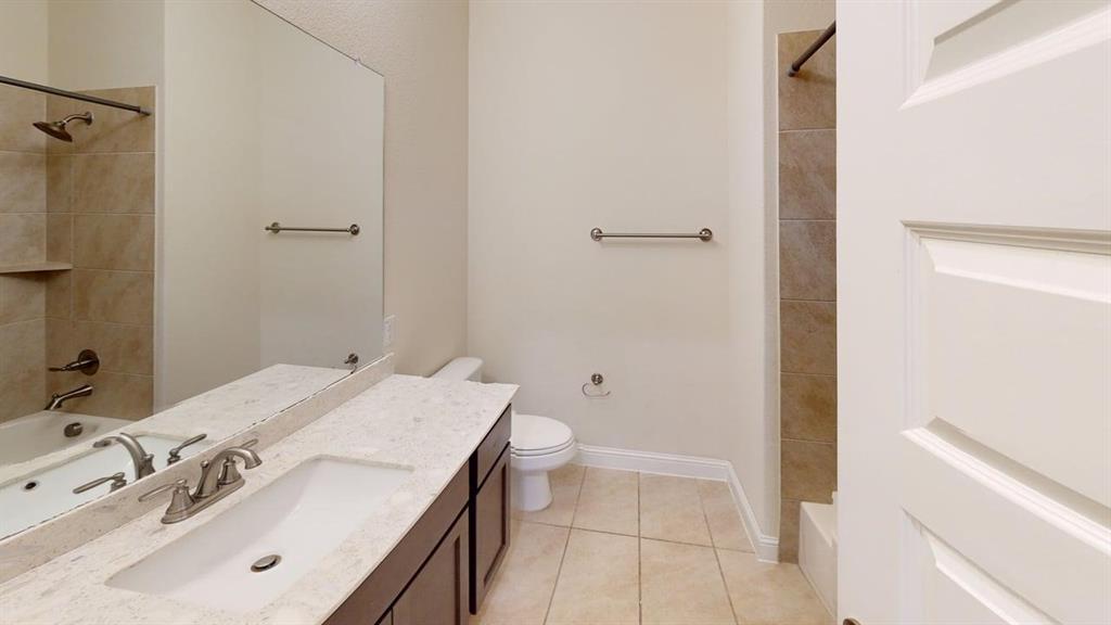 3314 Willena Road Melissa, TX 75454 - Photo 2 of 24 Dual vanity with marble-finish countertops and brushed nickel fixtures, ceramic tile flooring, and abundant natural lighting