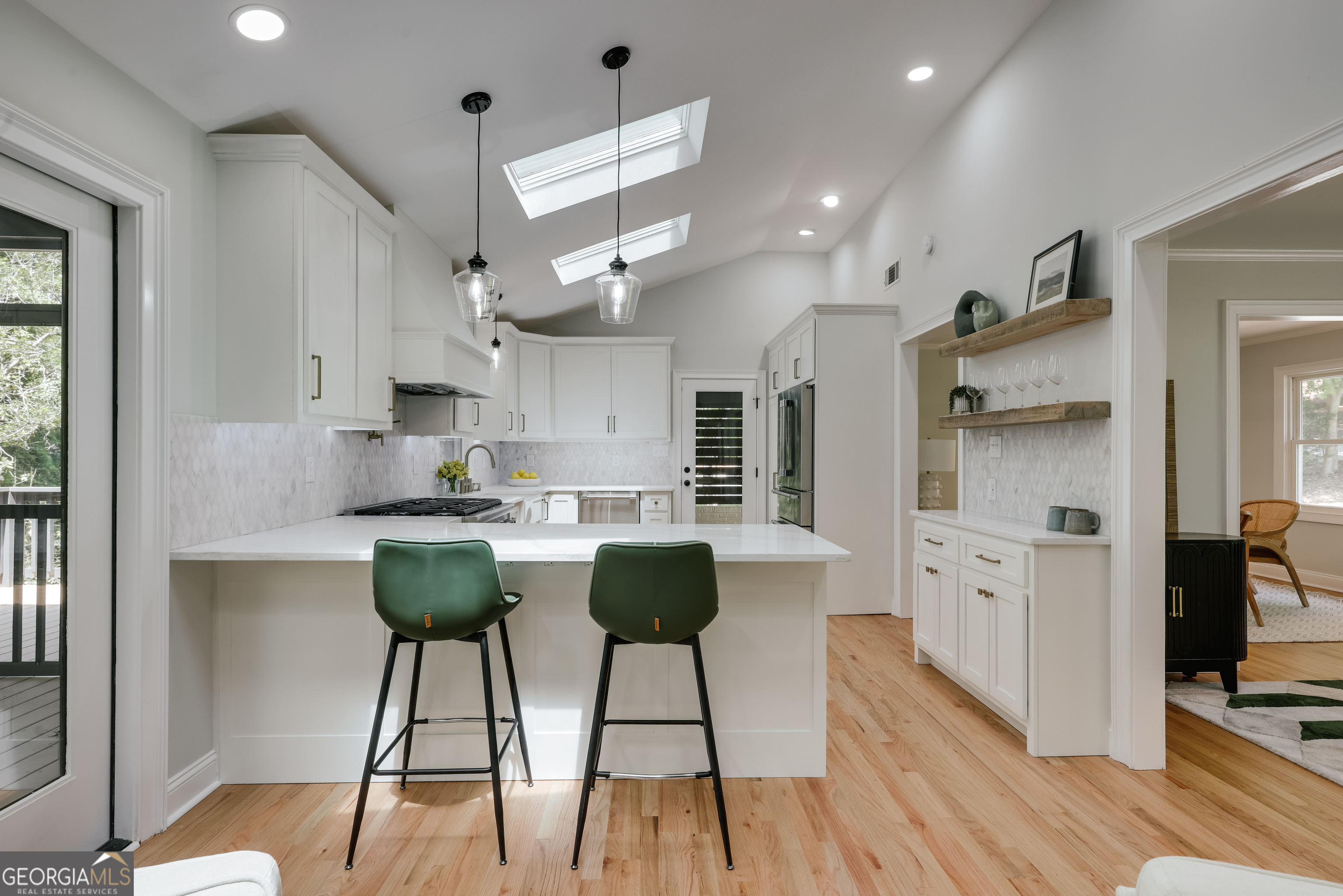 290 Fortson Drive Athens, GA 30606 - Photo 12 of 61 a kitchen with stainless steel appliances kitchen island granite countertop a refrigerator a stove a oven with white cabinets and wooden floor