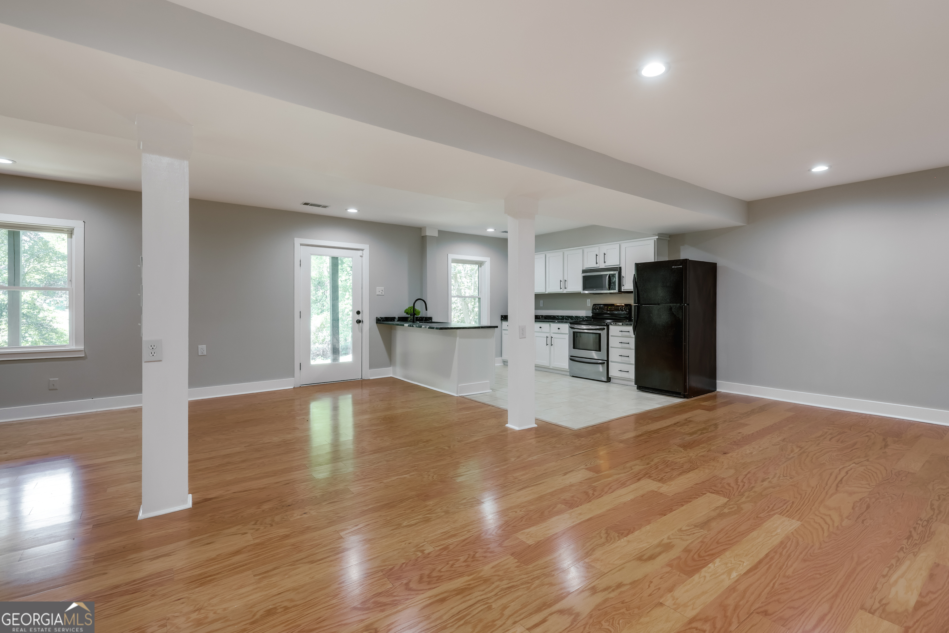 290 Fortson Drive Athens, GA 30606 - Photo 42 of 61 a view of empty room with wooden floor and kitchen